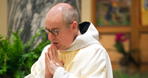 monk praying at mass