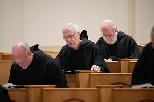 A photo of a monk praying at Mass.